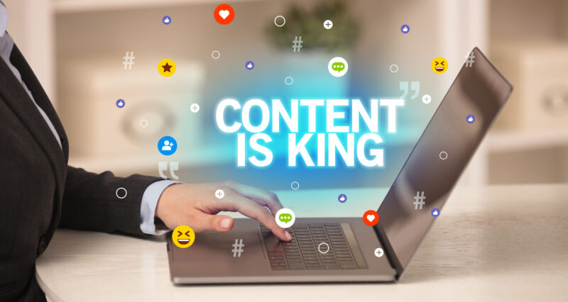 women using laptop and the image states content is king - showing the importance of content creation