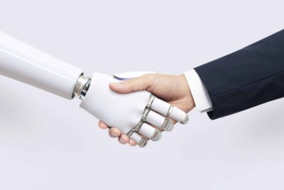 AI tools - AI hand with human handshake, symbolizing the team effort of AI tools with human intervention 